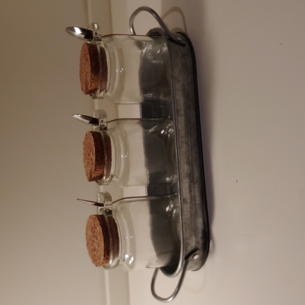 Galvanized metal tray with 3 clear jam jars and spoons.